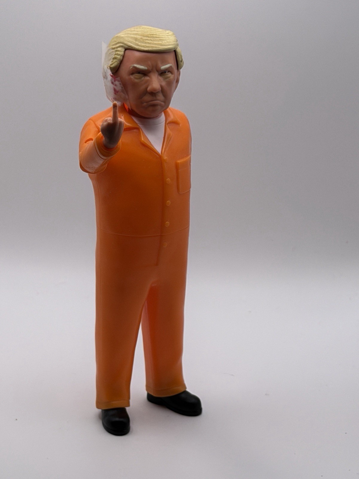 Collectible Donald Trump Doll – Prison Suit (w/ “shot” ear and soiled diaper)
