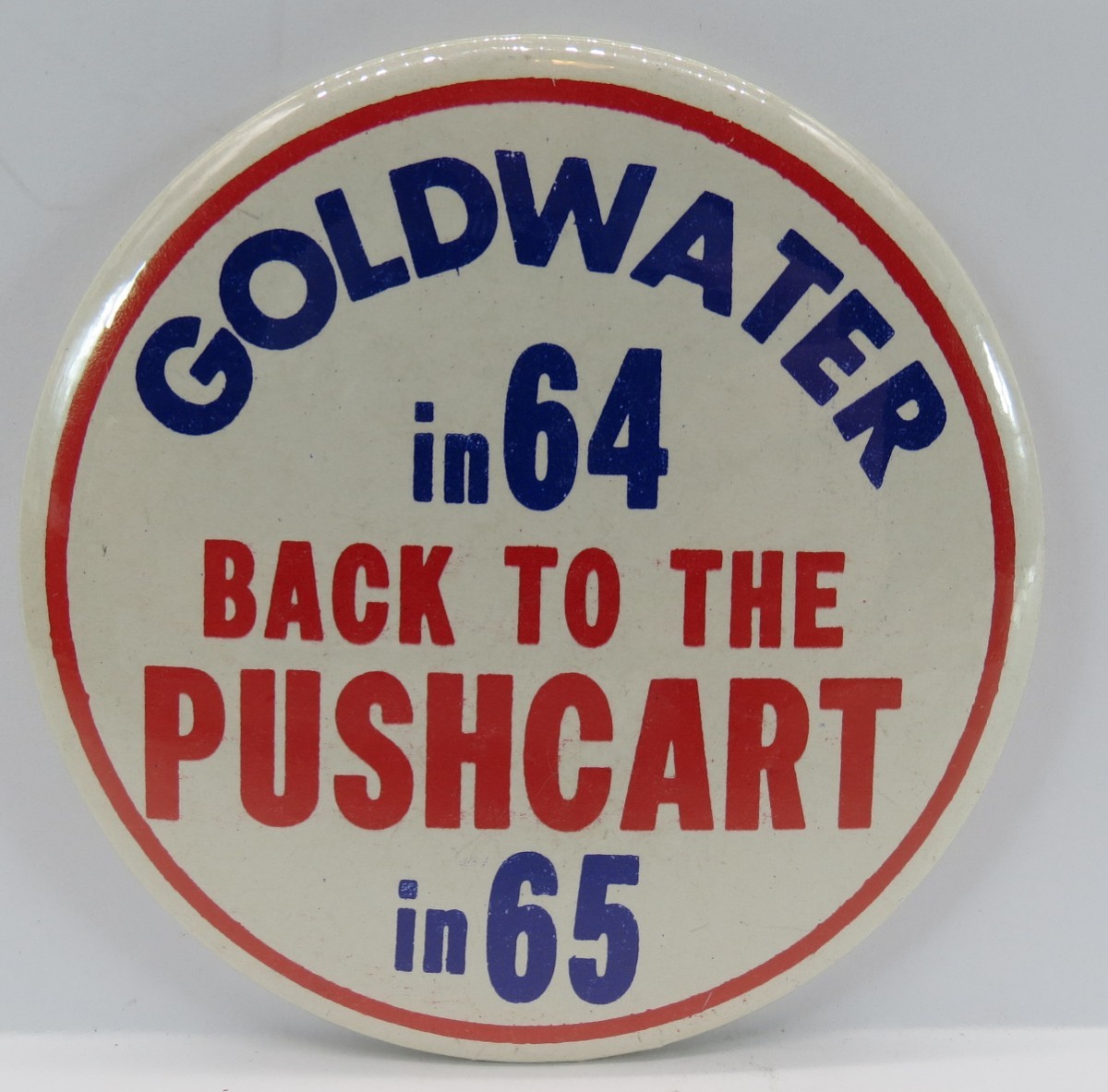 BARRY GOLDWATER IN 64 BACK TO THE PUSHCART IN 65 CAMPAIGN BUTTON 3.5″