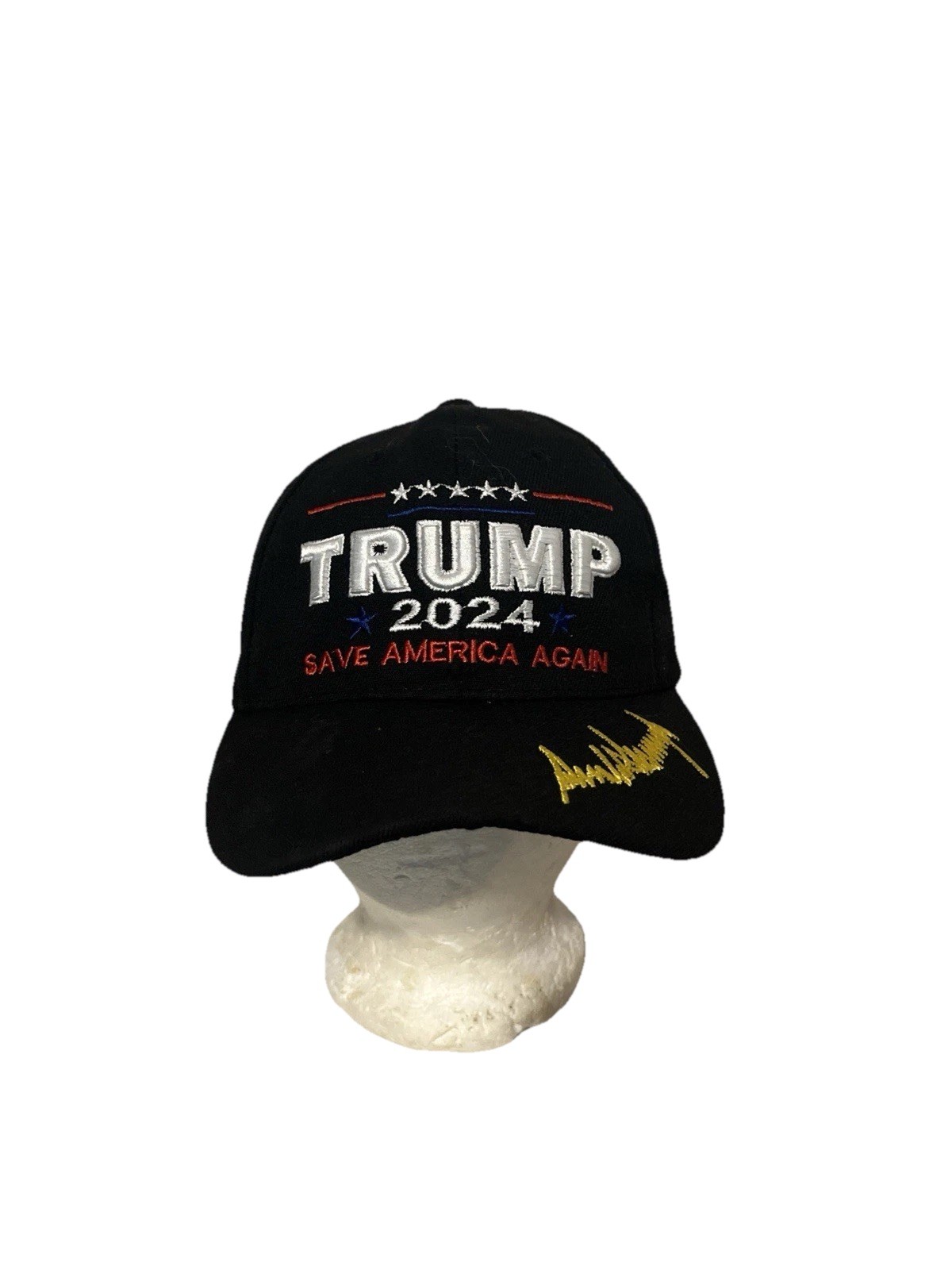 This is a black TRUMP 2024 SAVE AMERICA AGAIN text and a golden-yellow signature