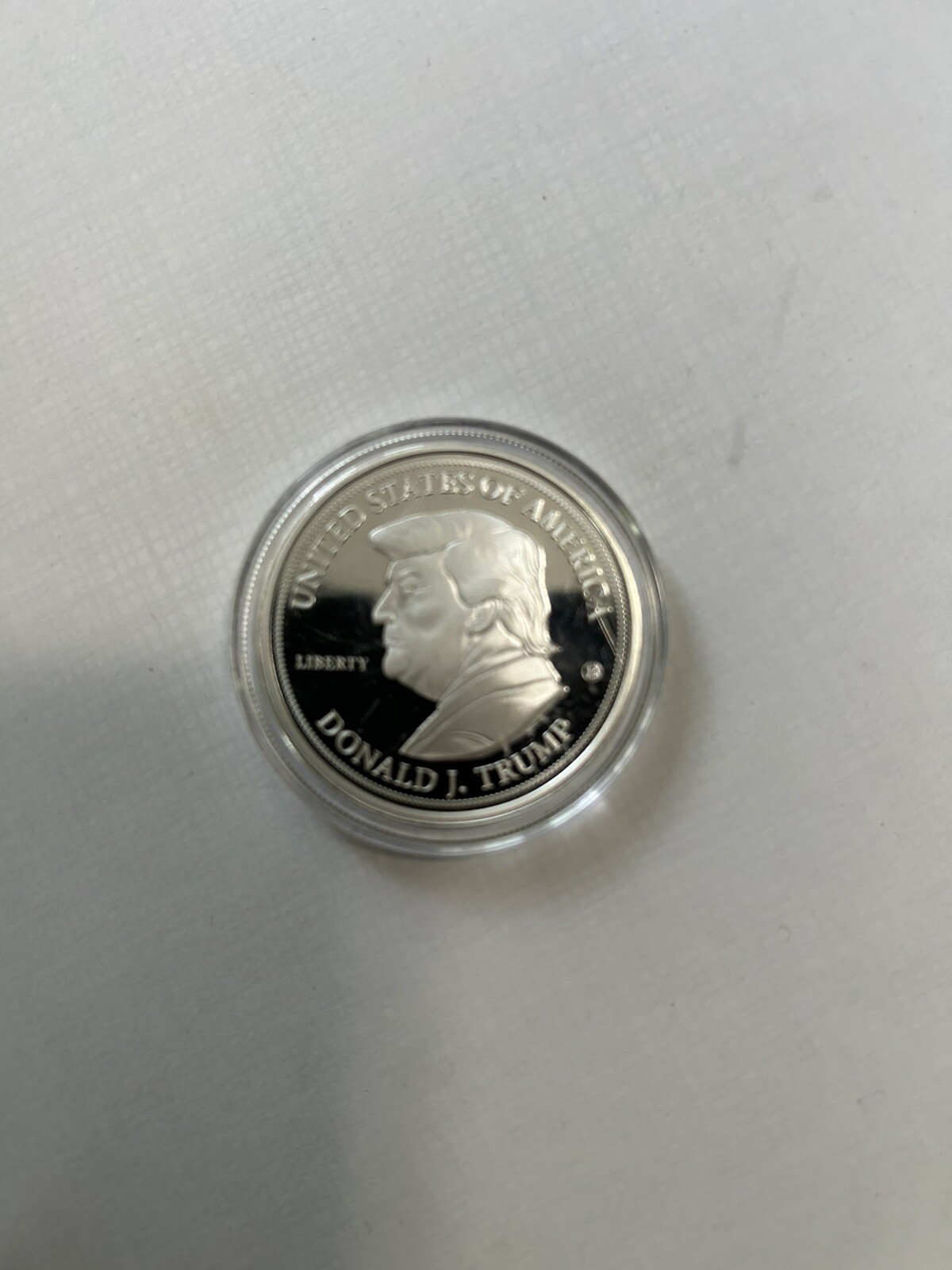 Two 2024 Donald J. Trump 99.9% Silver-Plated Proof Coins And 15 Coin Holder Case